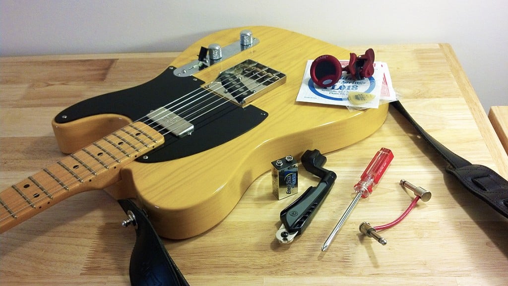 guitar with string changing supplies