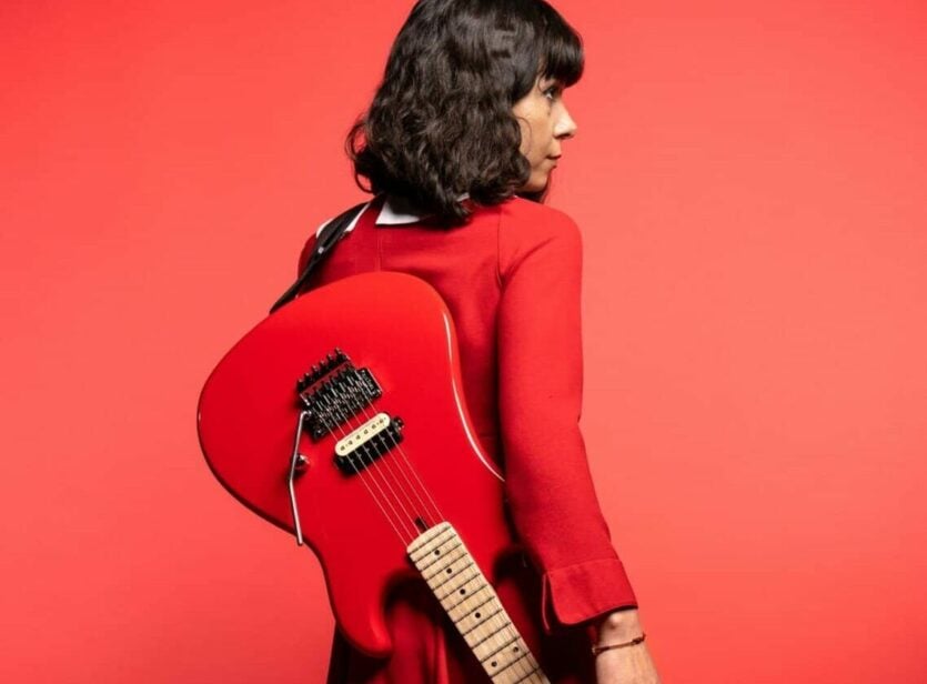 red guitar with 78 model pickup on back of woman